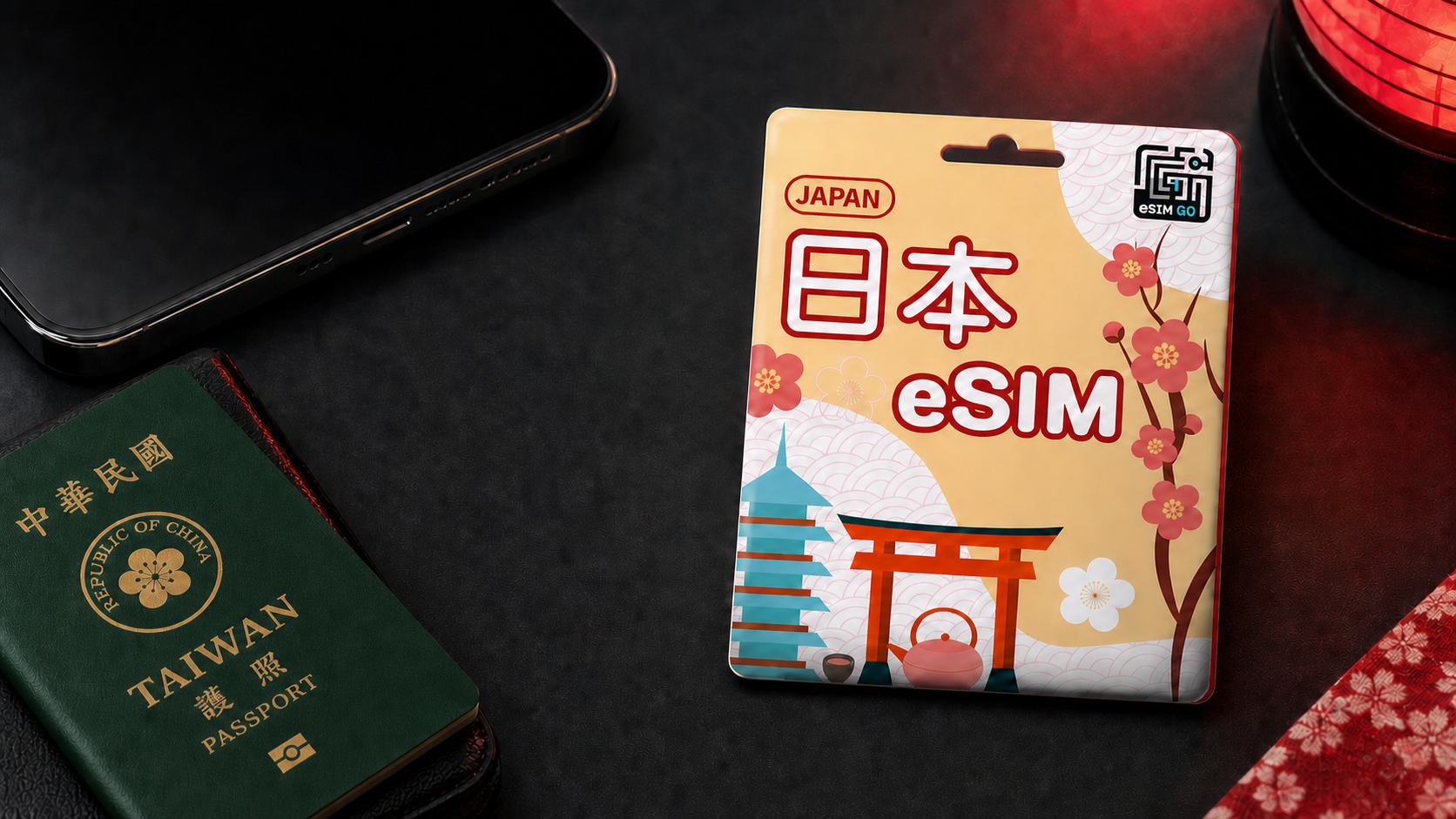 暗色旅行桌面上的日本 eSIM 商品、手機與台灣護照